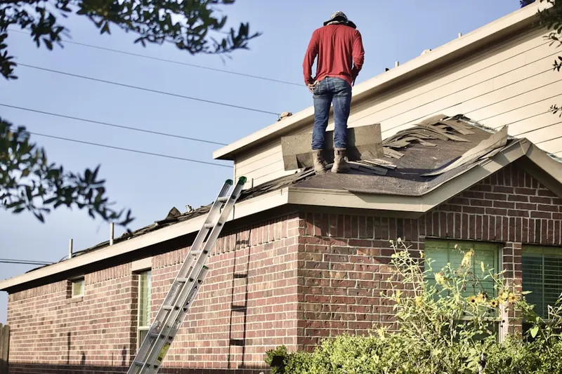 Professional roofer working on a residential roof in Scribner Corners